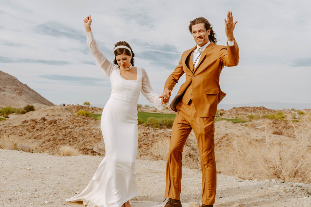 Newlyweds celebrating at end of ceremony — Desert Wedding Photography by Mattie O'Neill
