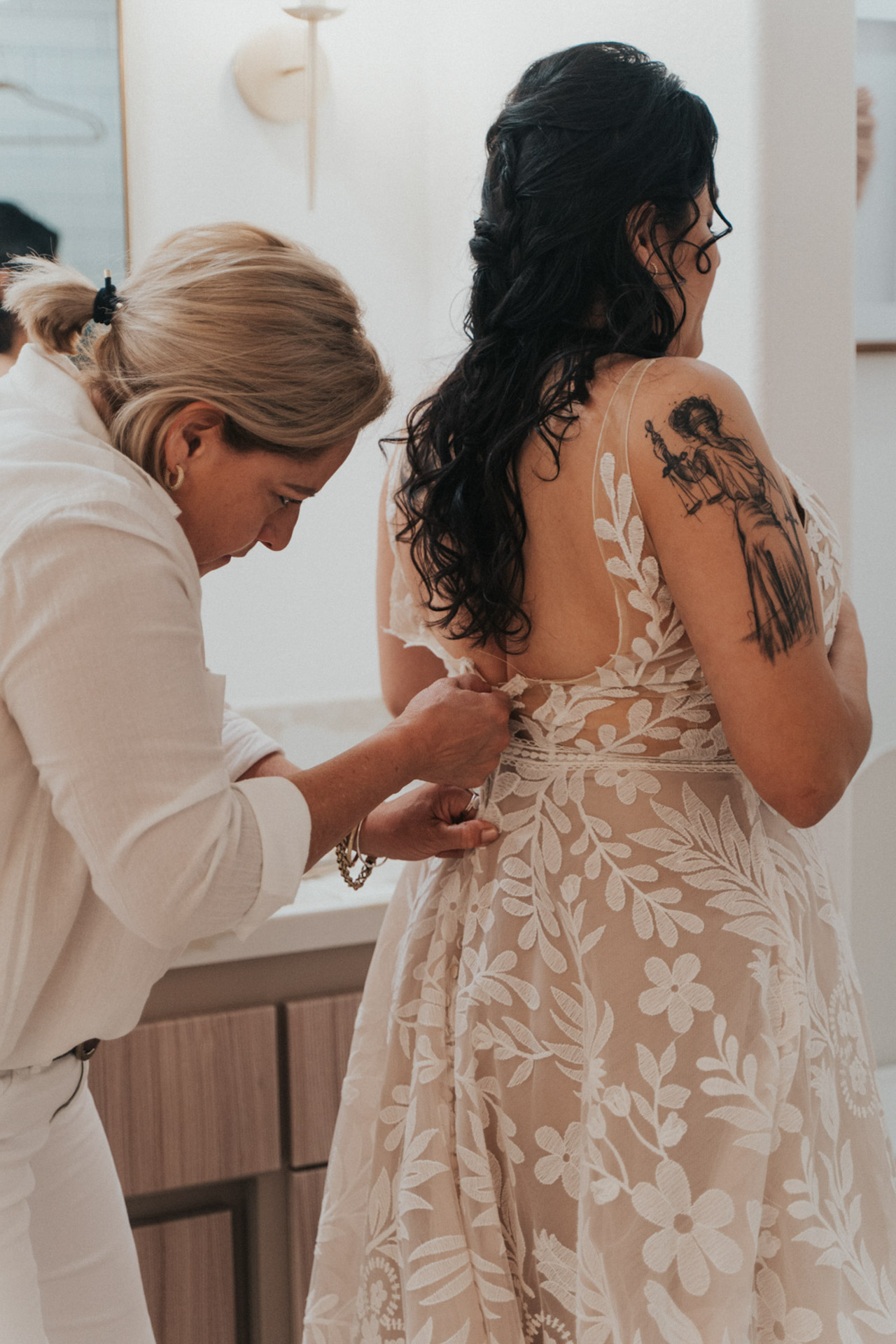 Mother of the bride helping her put her dress on — Joshua Tree Wedding Photographer 