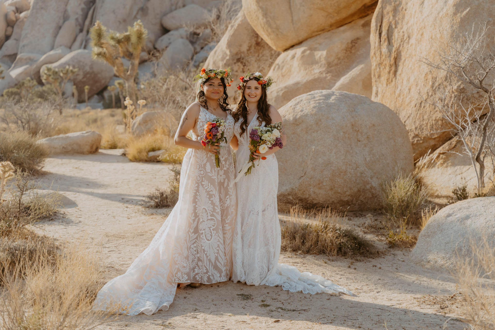 Brides posing for a photo in front of desert landscape — Joshua Tree Wedding Photographer