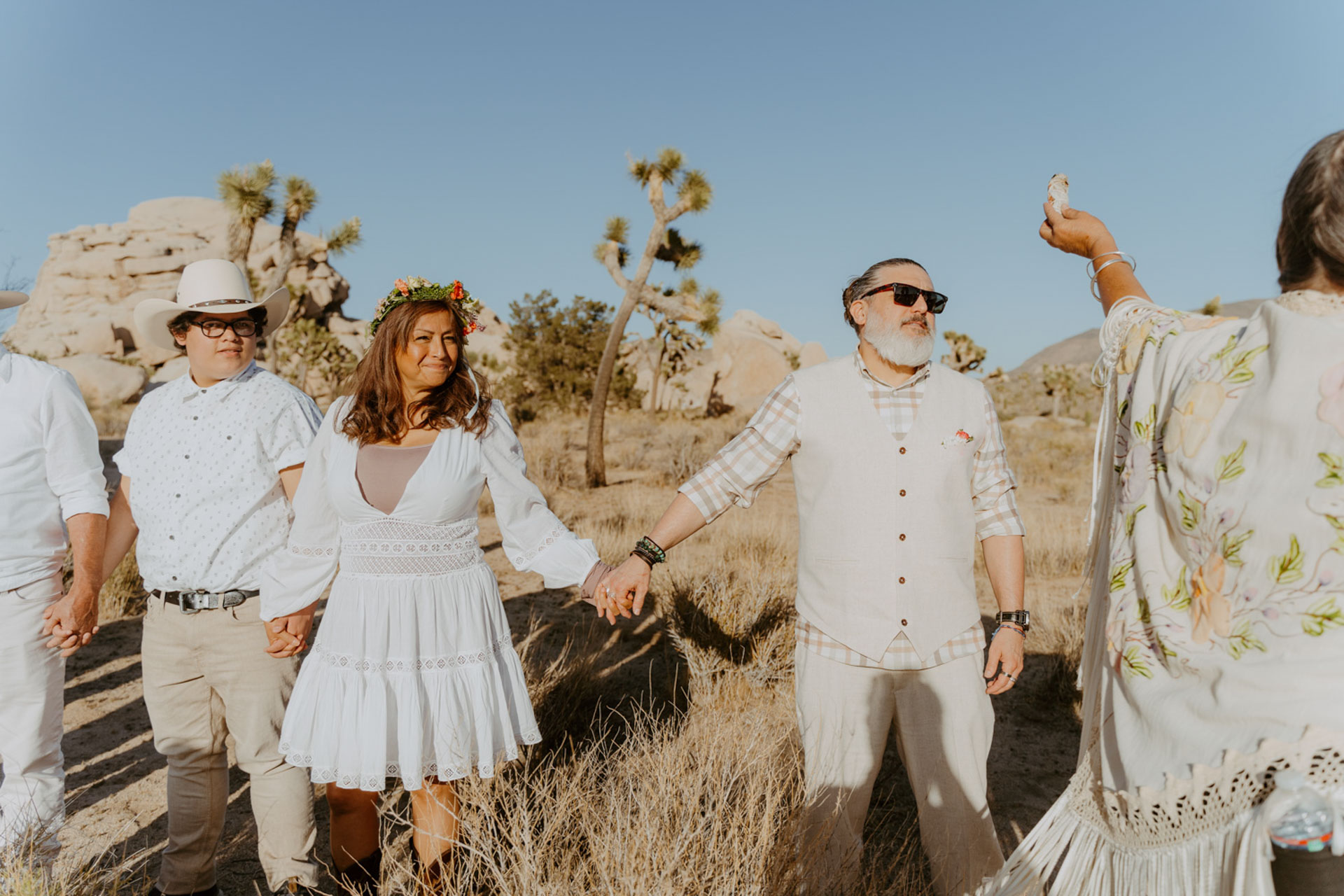 Parents of the bride at the ceremony, holding hands — Joshua Tree Wedding Photographer