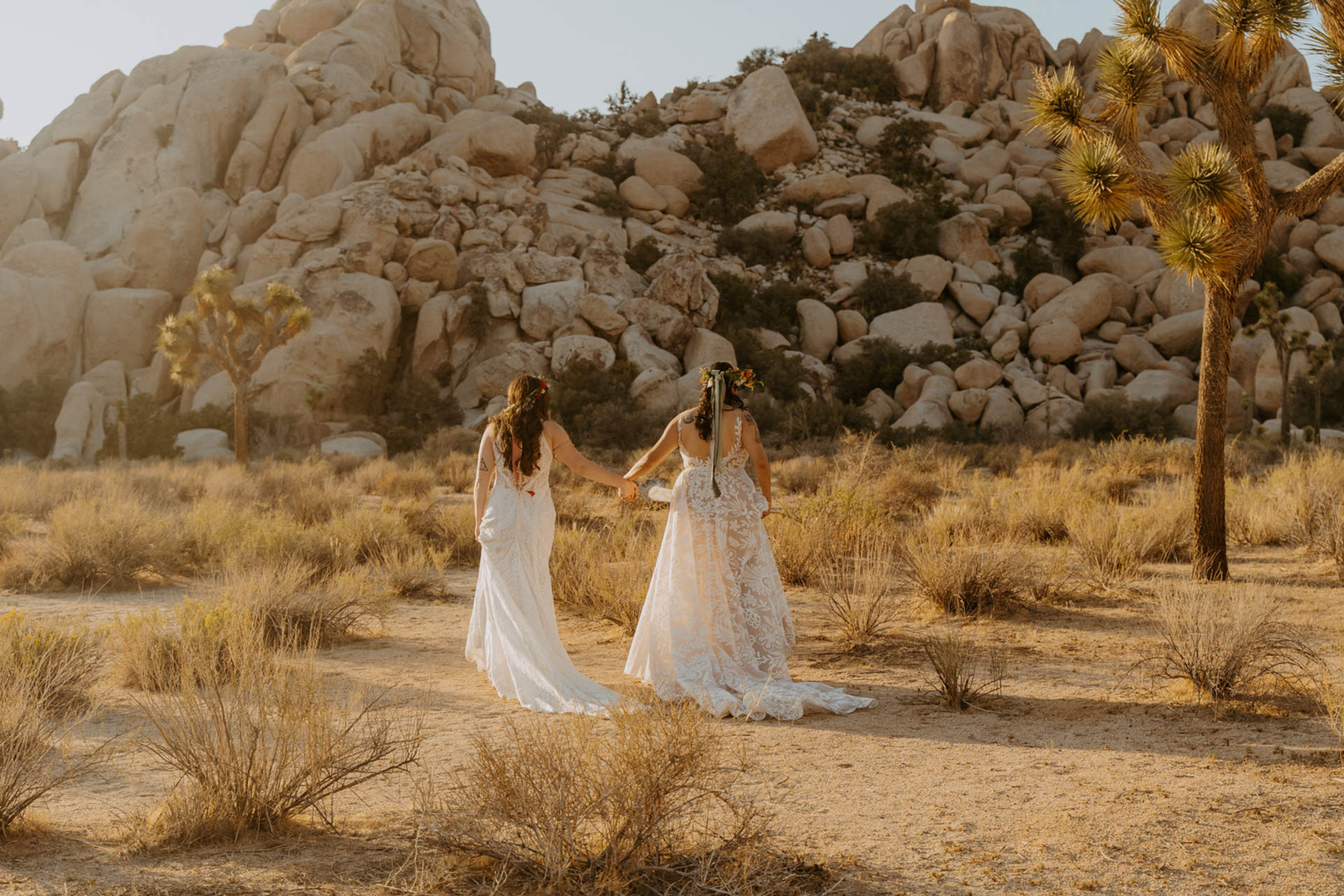 Bridge holding hands whiling walking through Hidden Valley — Joshua Tree Wedding Photographer